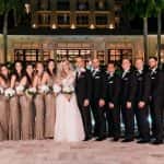 Bride and groom with their wedding party dressed in sequin gowns and tuxes