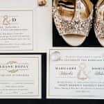 Wedding invitation with bride's wedding shoes and the couple's wedding rings